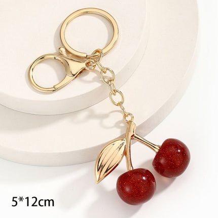 Mini bubble textured red cherry keychain with single gold leaf, dreamy soft sweetness follows you on every outing