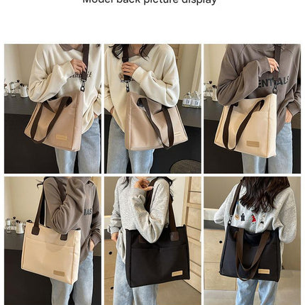 Stylish black canvas tote bag with detachable shoulder strap