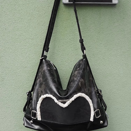 Stylish black tote backpack with heart embellishment - can be worn on one shoulder or as a backpack
