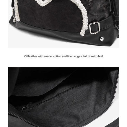 Stylish black tote backpack with heart embellishment - can be worn on one shoulder or as a backpack