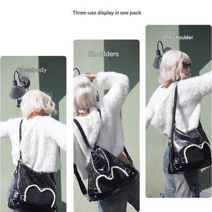 Stylish black tote backpack with heart embellishment - can be worn on one shoulder or as a backpack