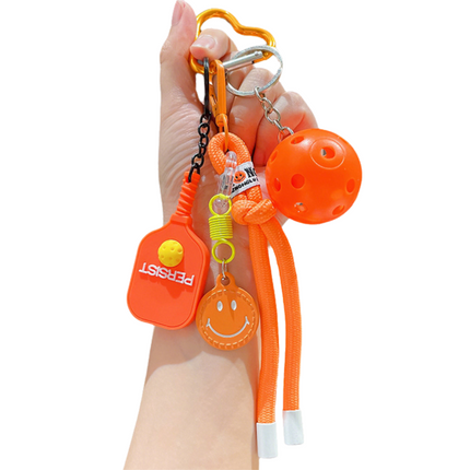 1 Piece Pickleball Keychain Bag Charm - Orange Sports Pendant with Mini Paddle, Ball, Smiley Charm and Woven Cord, Cute Gift Friendly Key Ring for Bags, Backpacks and Keys