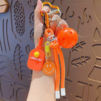 1 Piece Pickleball Keychain Bag Charm - Orange Sports Pendant with Mini Paddle, Ball, Smiley Charm and Woven Cord, Cute Gift Friendly Key Ring for Bags, Backpacks and Keys