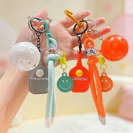 1 Piece Pickleball Keychain Bag Charm - Orange Sports Pendant with Mini Paddle, Ball, Smiley Charm and Woven Cord, Cute Gift Friendly Key Ring for Bags, Backpacks and Keys