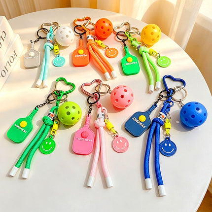 1 Piece Pickleball Keychain Bag Charm - Pink Sports Pendant with Mini Paddle, Ball, Smiley Charm and Woven Cord, Cute Gift Friendly Key Ring for Bags, Backpacks and Keys