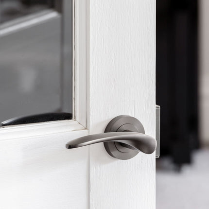 7033.GN | Apollo Door Handle Lever on Round Rose Passage Set Graphite Nickel | Zanda Architectural